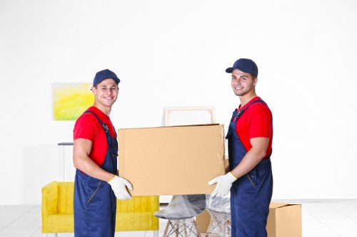 Removal helpers loading furniture for a Heston house move