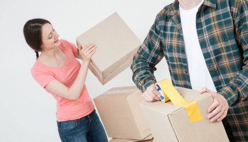 Business relocation crew handling commercial items carefully during loading
